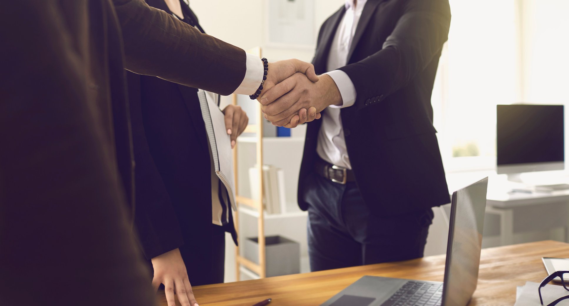 Businesspeople Shaking Hands in Office 
